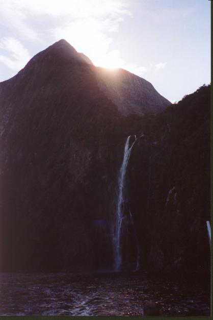 A waterfall, sun setting over mountain
